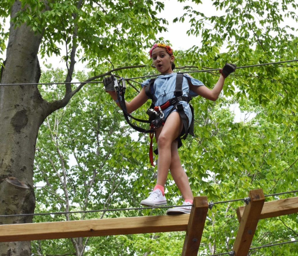 girl on wooden obstacle in Boundless Adventures
