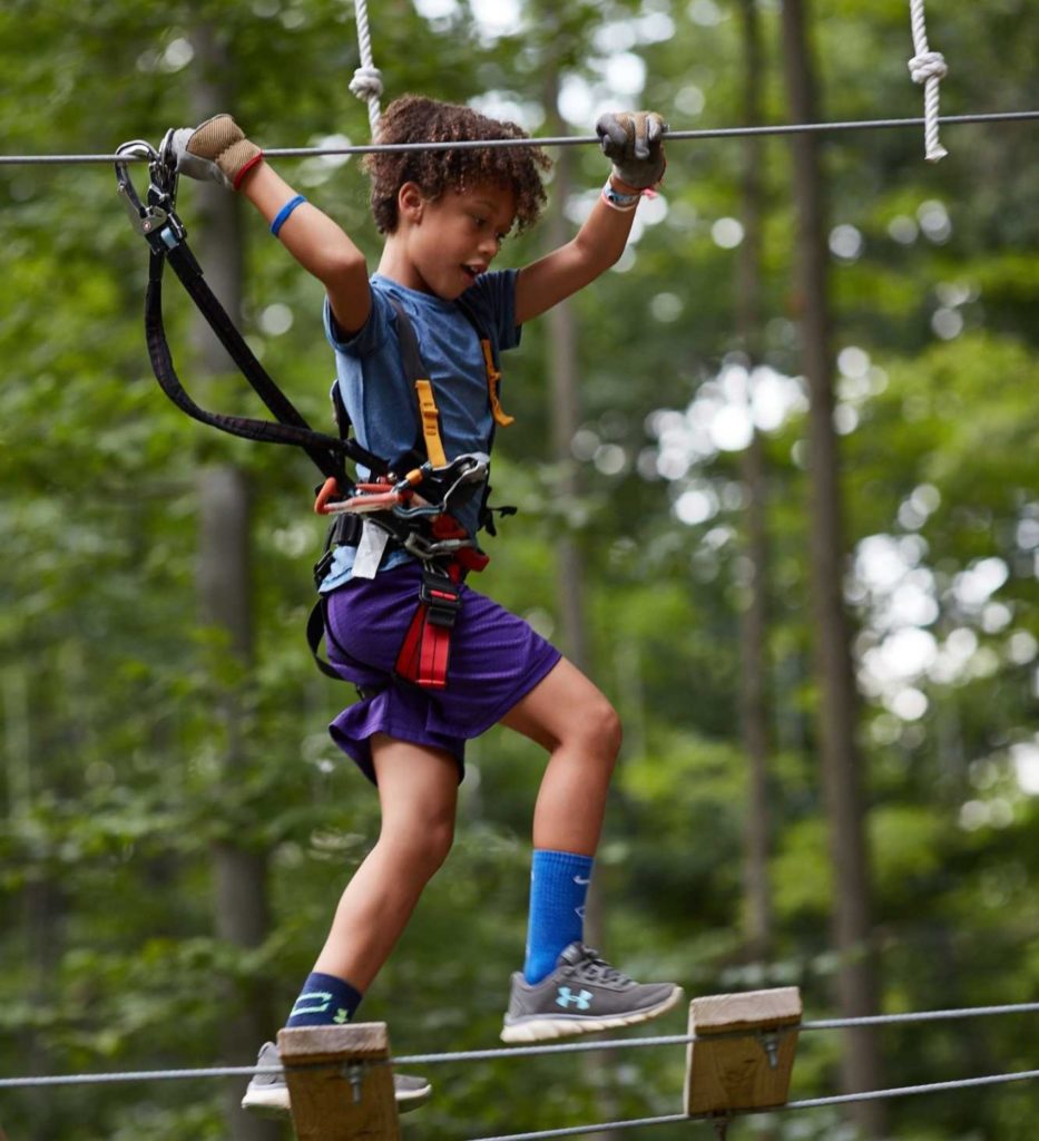 boy on a rope element in our aerial adventure park Boundless Adventures in Purchase New York