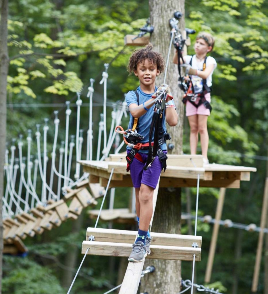 boy on a rope bridge at Boundless Adventures high ropes course