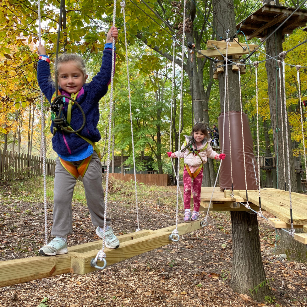2 girls celebrating a birthday party on a ropes course