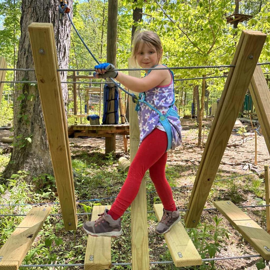 little girl on rope course