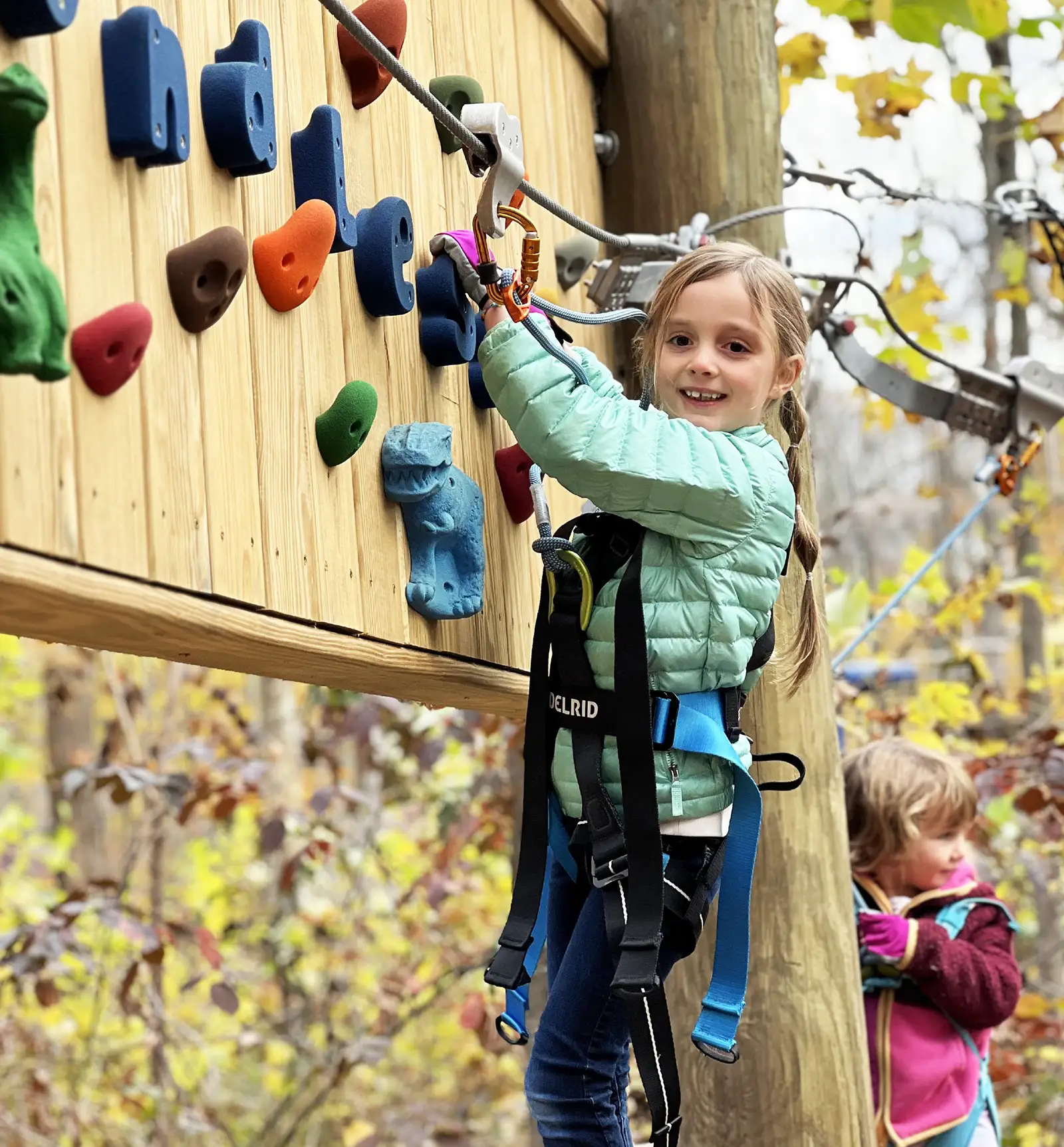 Girl using climbing grips on the Junior Explorer course